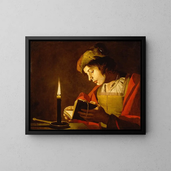 Ein junger Mann liest im Licht einer Kerze - Matthias Stom — gerahmtes Bild an der Wand