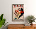 Vintage advertising poster Oscaria, shoes, framed above a wooden dresser between plants.