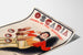 Vintage advertising poster Oscaria, shoes, presented on a curled sheet, viewed in perspective.