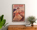 Vintage advertising poster Paris–Niort, summer novelties, framed above a wooden dresser, between plants.