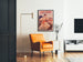 Vintage advertising poster Paris–Niort, summer novelties, framed in a living room with an orange armchair and a floor lamp.