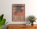 Poster vintage Fort-de-France, festa di beneficenza, incorniciato sopra una cassettiera in legno, tra piante.