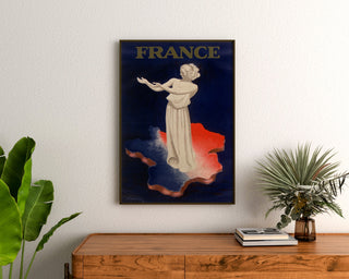 Vintage France poster, Paris 1937 exhibition, framed above a wooden dresser, between plants.