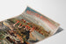 Vintage Paris Lyon Méditerranée, Jura poster displayed on a curled sheet, shown in perspective.