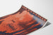 Vintage Pyrénées — Grottes de Bétharram poster, presented on a curled sheet, seen in perspective.