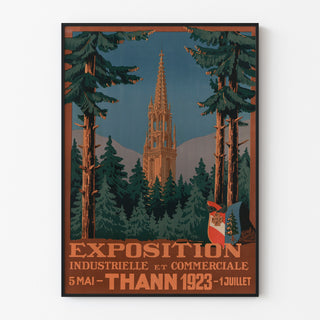 Vintage Thann industrial exhibition poster, displayed in a slim frame on a light wall.